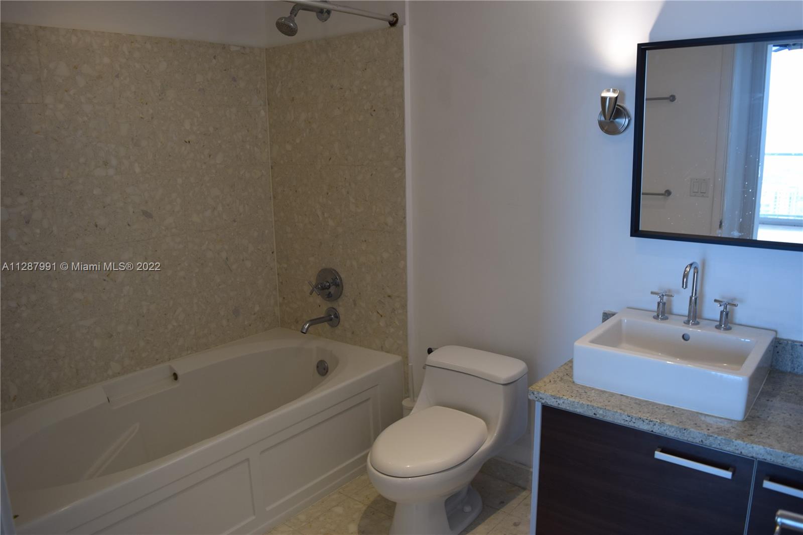 185 Southwest 7th Street, Unit 4014 Miami, FL 33130 - Photo 16 of 21 a bathroom with a sink toilet and vanity