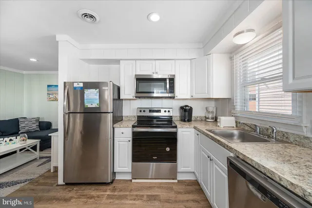 a kitchen with a sink stove and refrigerator
