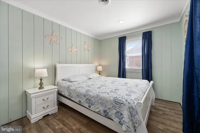 a bedroom with a bed and a night stand