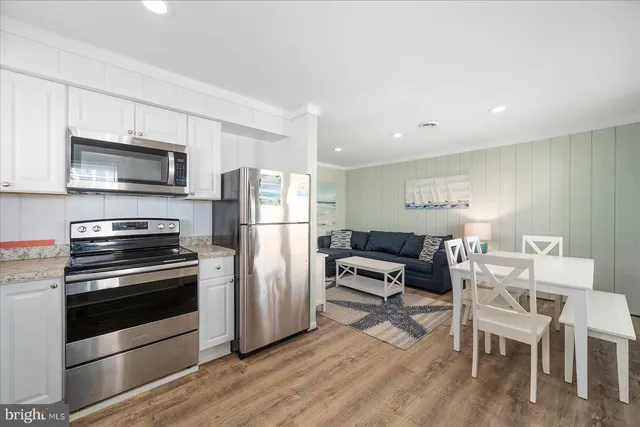 a kitchen with stainless steel appliances a stove a microwave and a refrigerator