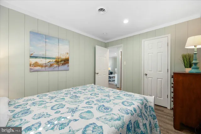 a bedroom with a bed and a mirror