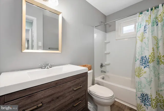 a bathroom with a sink a toilet and a bathtub