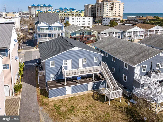 an aerial view of a house with a swimming pool and outdoor seating
