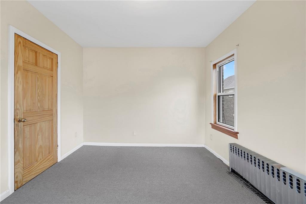 2602 Avenue T Brooklyn, NY 11229 - Photo 16 of 27 a view of an empty room with wooden floor and a window