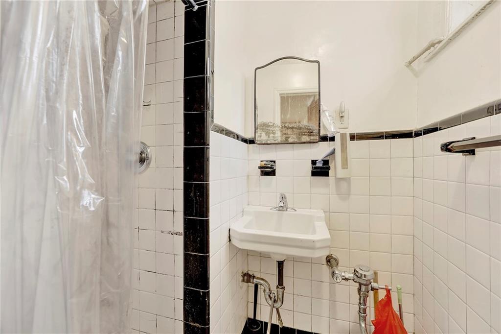 2602 Avenue T Brooklyn, NY 11229 - Photo 17 of 27 a bathroom with a sink and a mirror