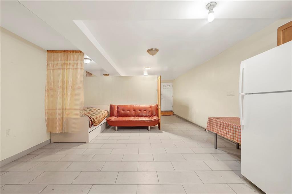 2602 Avenue T Brooklyn, NY 11229 - Photo 18 of 27 a living room with furniture and a table