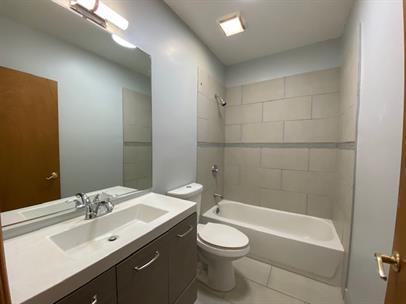 4221 South Union Avenue, Unit 3 Chicago, IL 60609 - Photo 13 of 16 a bathroom with a sink a toilet and shower