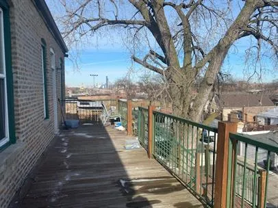 a view of a balcony with wooden floor