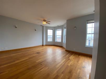 4221 South Union Avenue, Unit 3 Chicago, IL 60609 - Photo 2 of 16 a view of an empty room with window and wooden floor