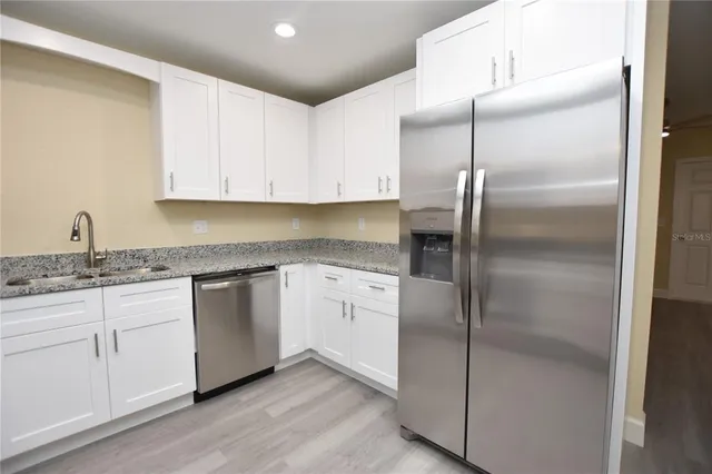 a kitchen with stainless steel appliances a refrigerator and a stove