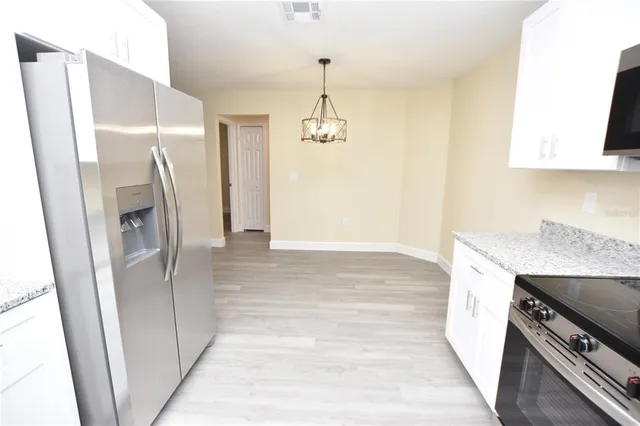 a view of a workspace with furniture and cabinet