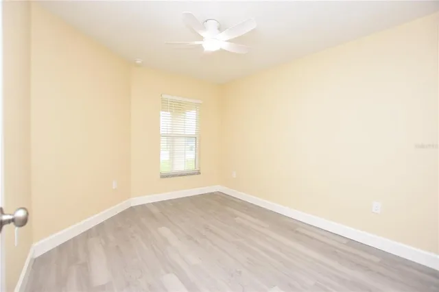 a bathroom with a granite countertop sink a toilet and a mirror