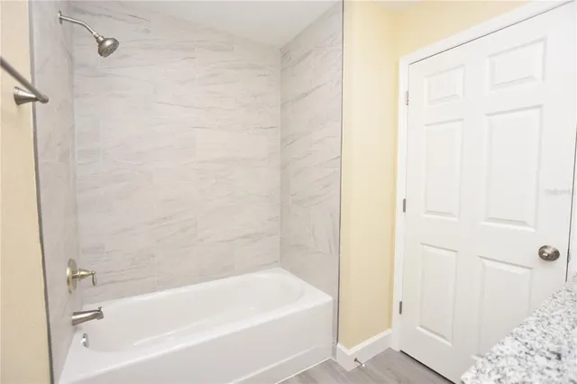 an empty room with a window and wooden floor