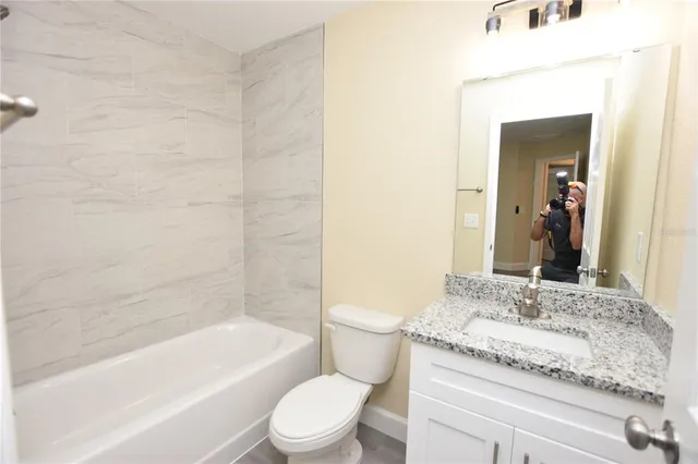 a bathroom with a toilet and a bathtub