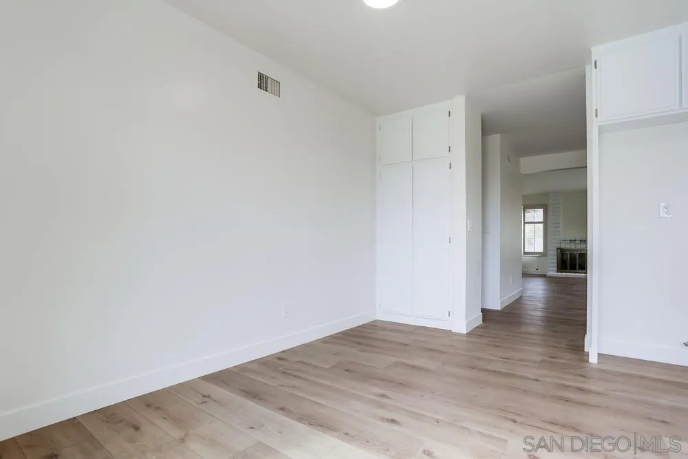 384 Compass Road Oceanside, CA 92054 - Photo 11 of 34 a view of an empty room with wooden floor and a window