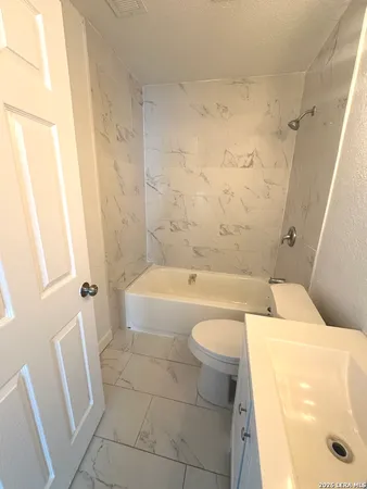a bathroom with a bathtub and sink