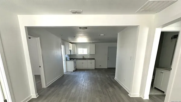 a view of a hallway with wooden floor