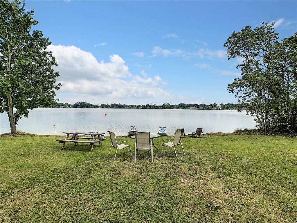a view of a lake with outdoor seating and city view