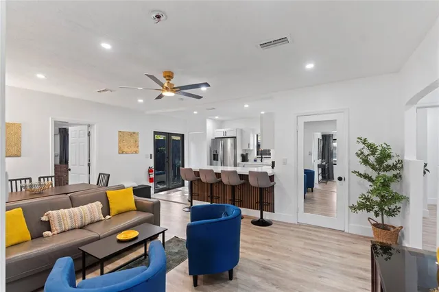 a living room with furniture and wooden floor