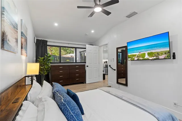 a bedroom with a bed and a chandelier