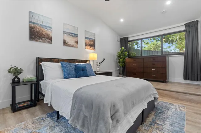 a bedroom with a large bed and a window