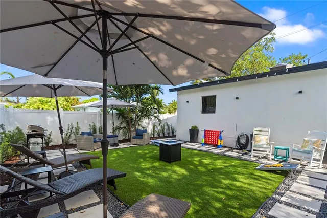 a view of a backyard with plants and a patio