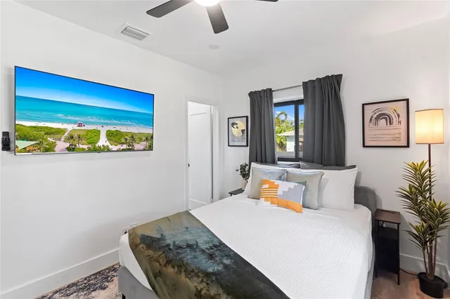 a bedroom with a bed and ceiling fan