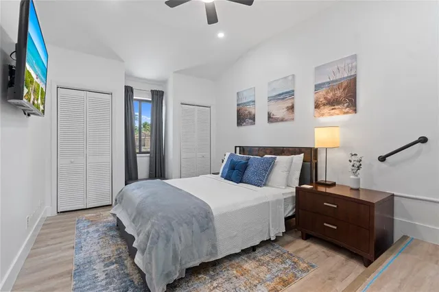 a bedroom with a bed and wooden floor