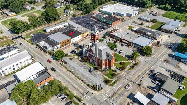 an aerial view of residential houses with outdoor space and parking