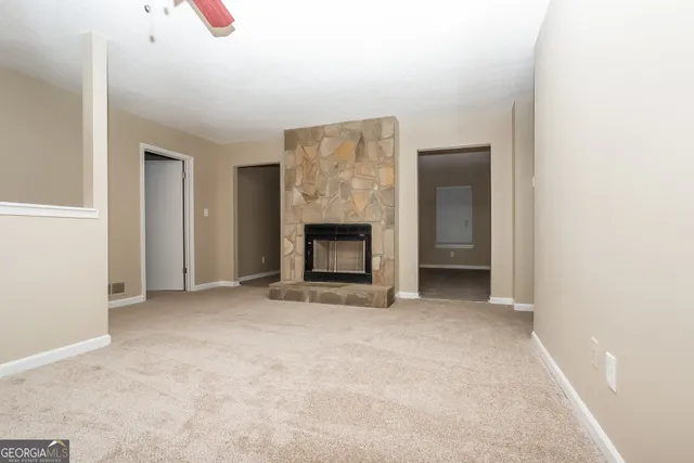 a view of an empty room with a fireplace
