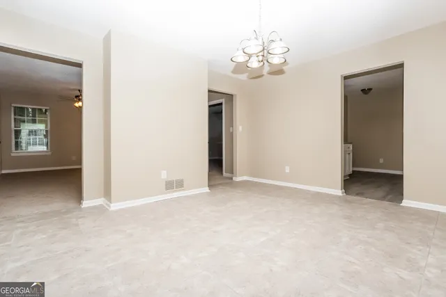 a view of a chandelier in big room and a mirror