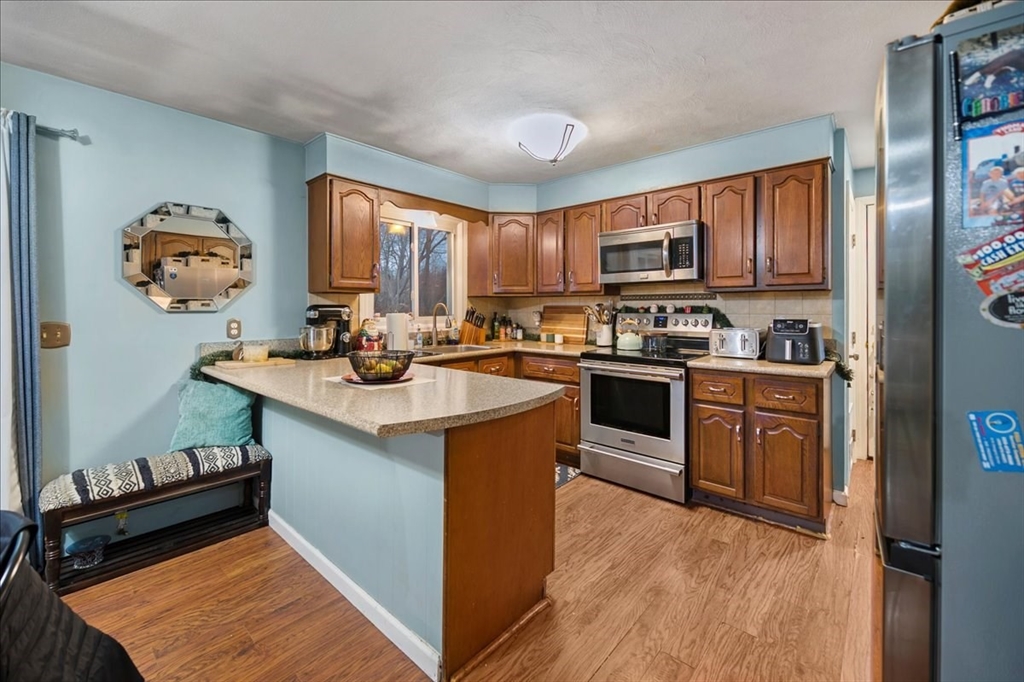 63 Hebb Street Somerset, MA 02725 - Photo 10 of 30 a kitchen with a sink stove top oven and refrigerator