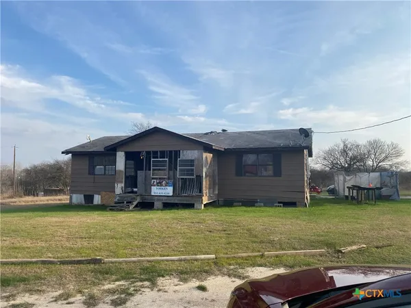 a view of a house with a yard