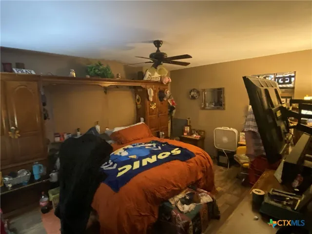 a bedroom with a bed and teddy bear