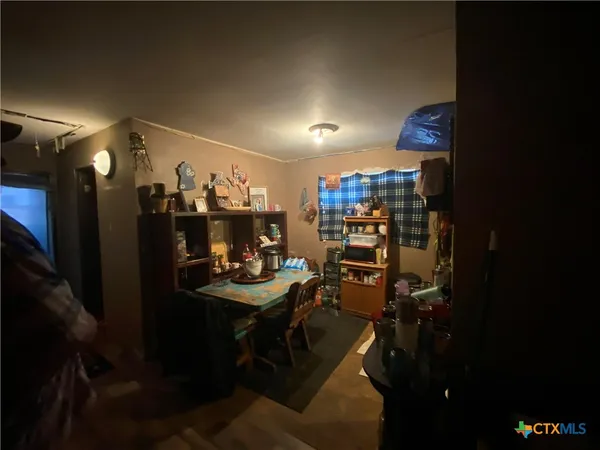 a bedroom with a bed and a lamp on the dresser