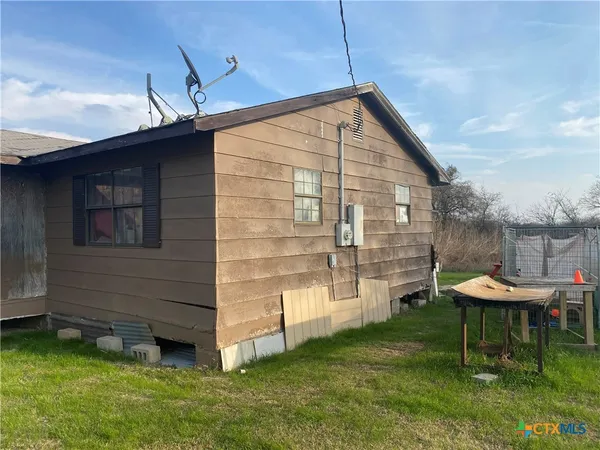 a backyard of a house with barbeque oven