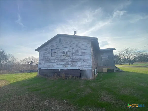 a view of a brick house with a yard