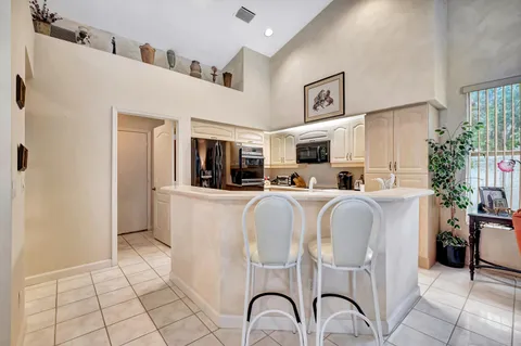 a kitchen with stainless steel appliances kitchen island granite countertop a sink and cabinets