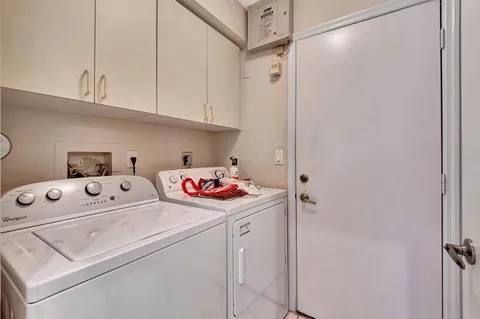 a view of walk in closet with clothes