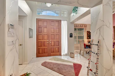 a living room with fireplace furniture and a large window