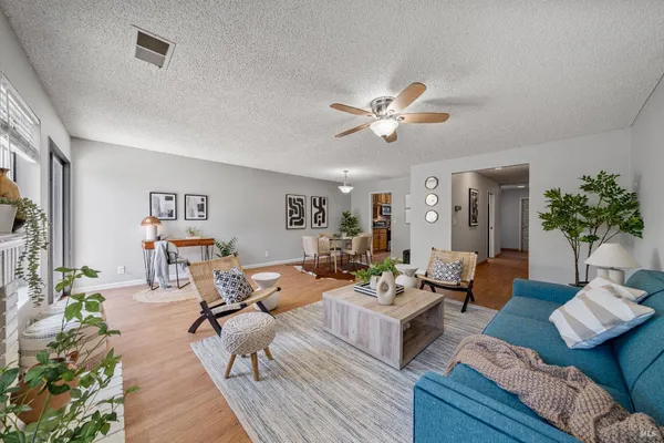 a living room with furniture potted plant and a chandelier