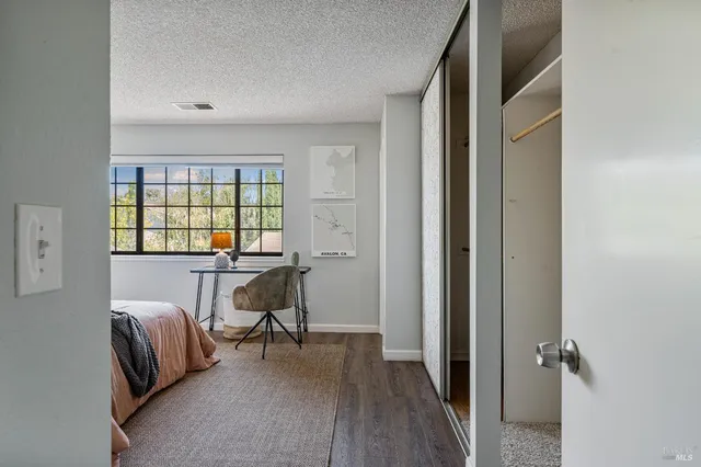 a view of a livingroom with furniture and a window