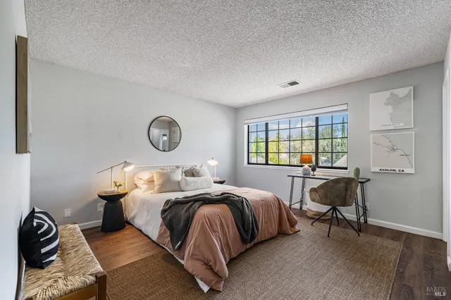 a bedroom with a bed and a table