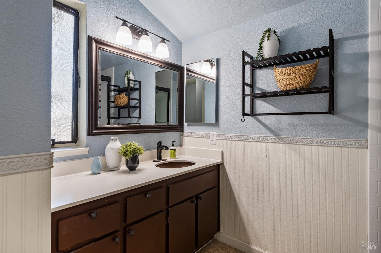 1740 Stuart Court Benicia, CA 94510 - Photo 22 of 38 a bathroom with a sink a vanity and a mirror