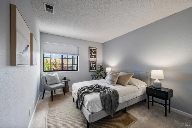 a bedroom with a bed and a lamp