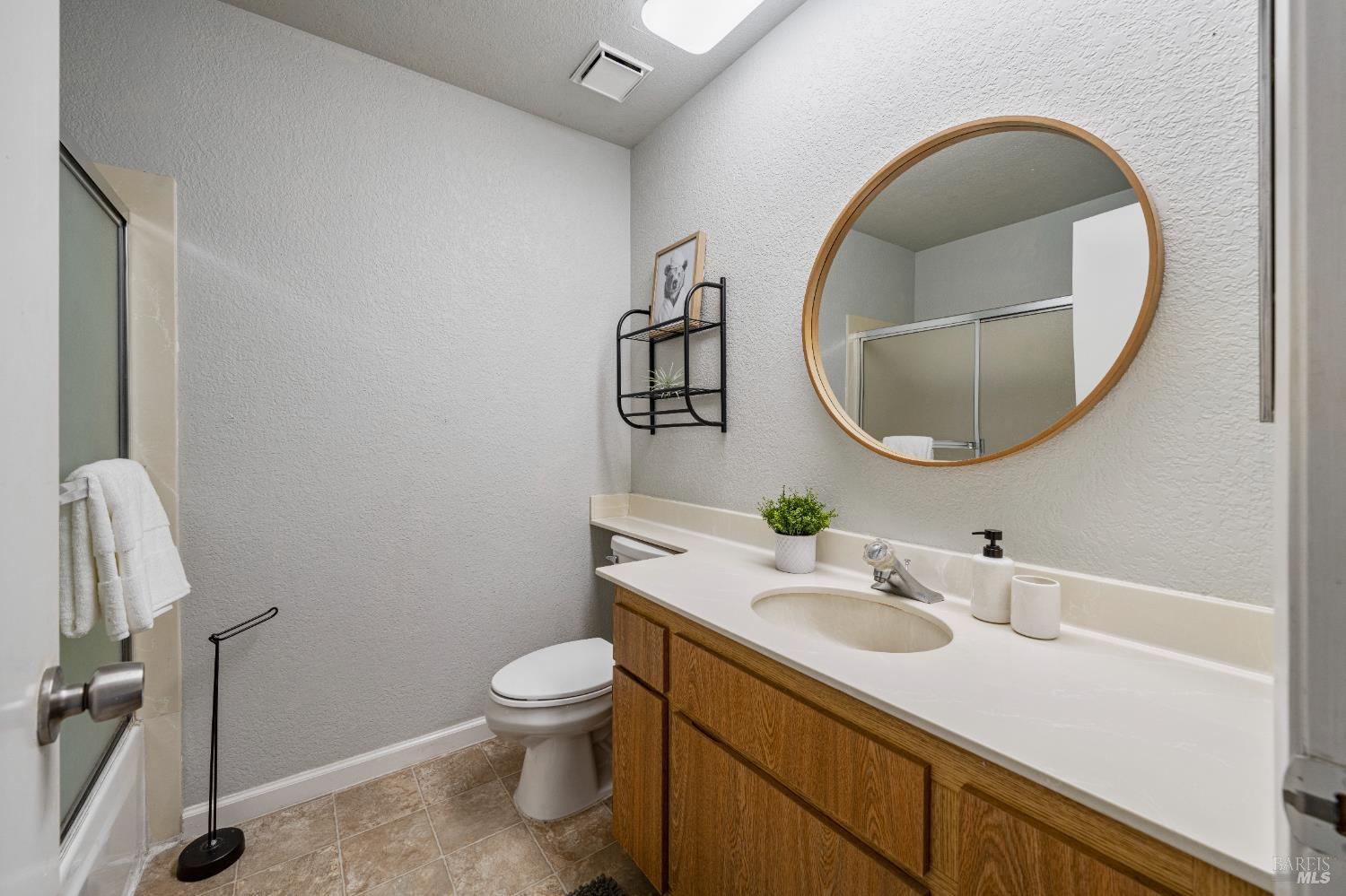 1740 Stuart Court Benicia, CA 94510 - Photo 25 of 38 a bathroom with a sink a toilet and a mirror