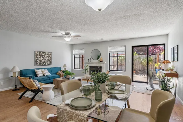 a living room with furniture chandelier and a table