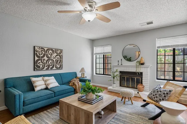 a living room with furniture fireplace and a fireplace