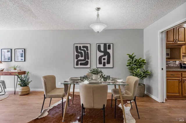 a dining room with furniture and window