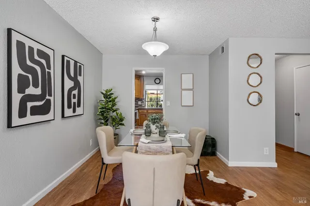a view of a dining room with furniture and wooden floor